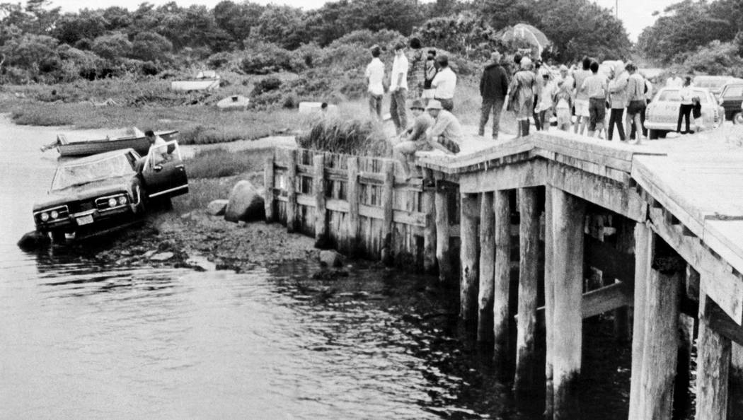 FILE - In this July 19, 1969 file photograph, crowds watch as U.S. Sen. Edward Kennedy's car is ...