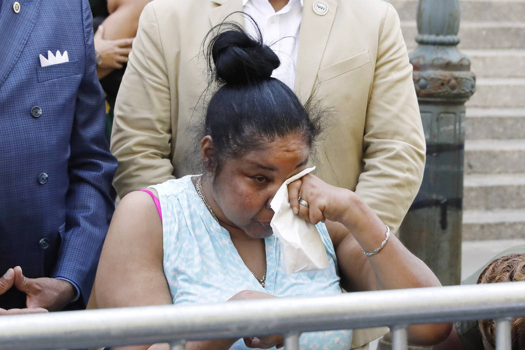 Esaw Snipes, widow of chokehold victim Eric Garner, wipes her eyes during a news conference out ...