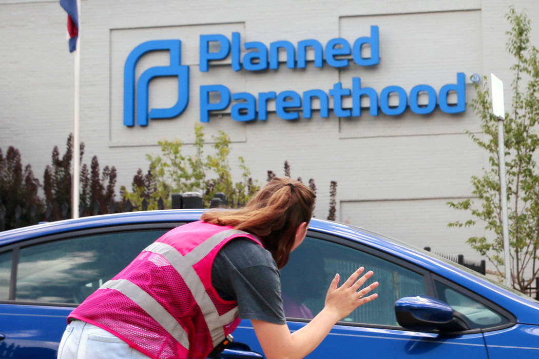 In a June 28, 2019, file photo, Ashlyn Myers of the Coalition for Life St. Louis, waves to a Pl ...