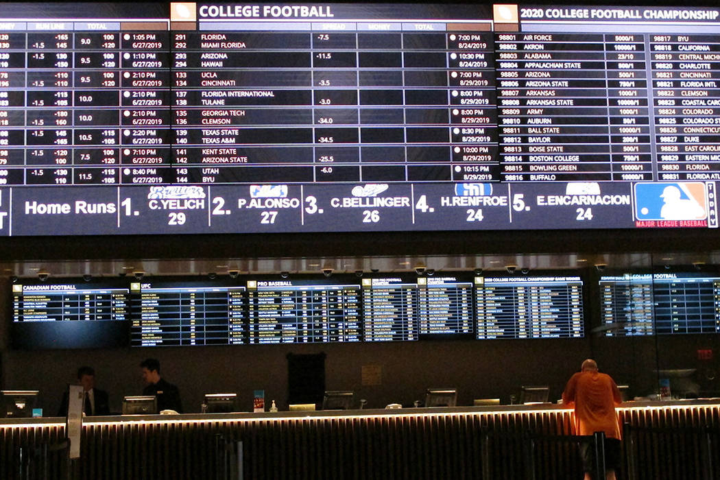 A gambler places a bet at the new sportsbook at Bally's casino in Atlantic City, N.J. on June 2 ...