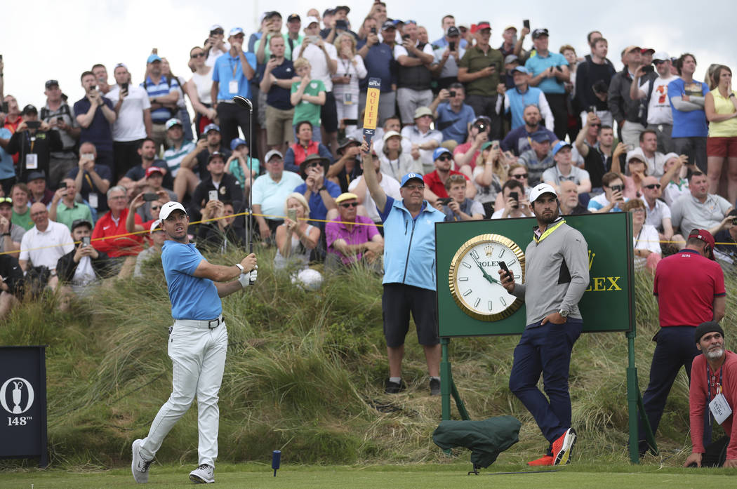 Northern Ireland's Rory McIlroy plays his shot off the 7th tee watched by spectators during a p ...