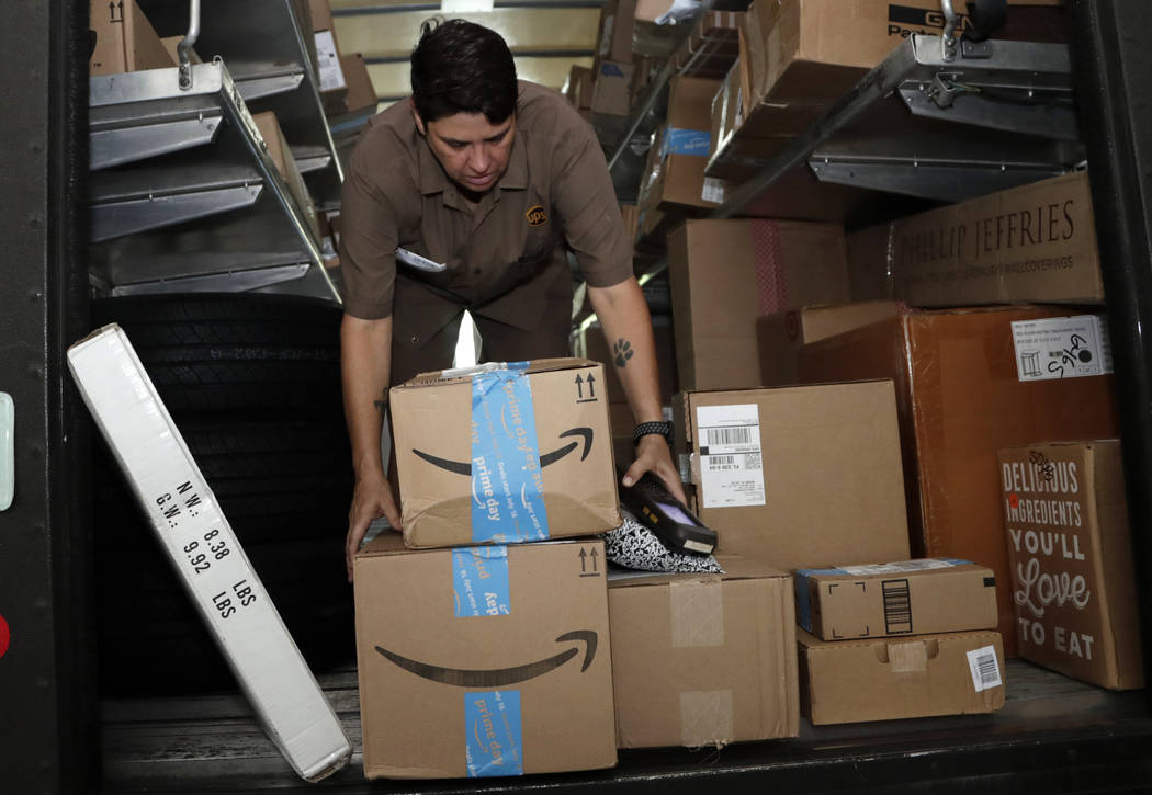 FILE - In this July 17, 2018, file photo UPS employee Liz Perez unloads packages for delivery i ...