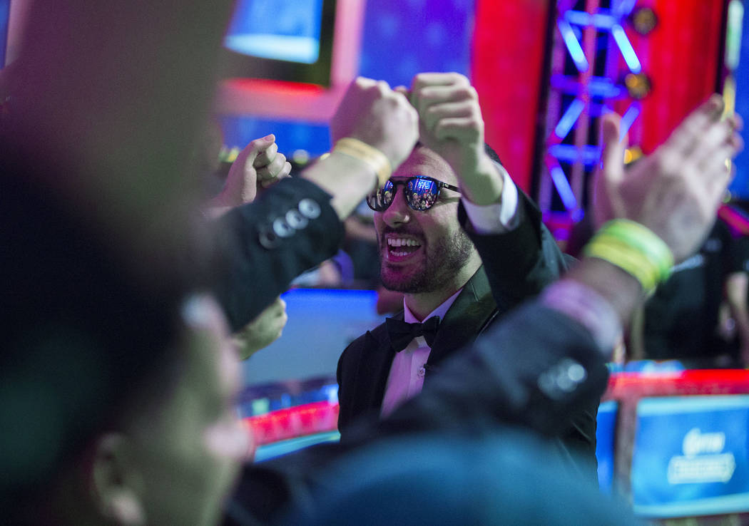 Dario Sammartino, right, from Italy, greets fans during a break at the the World Series of Poke ...