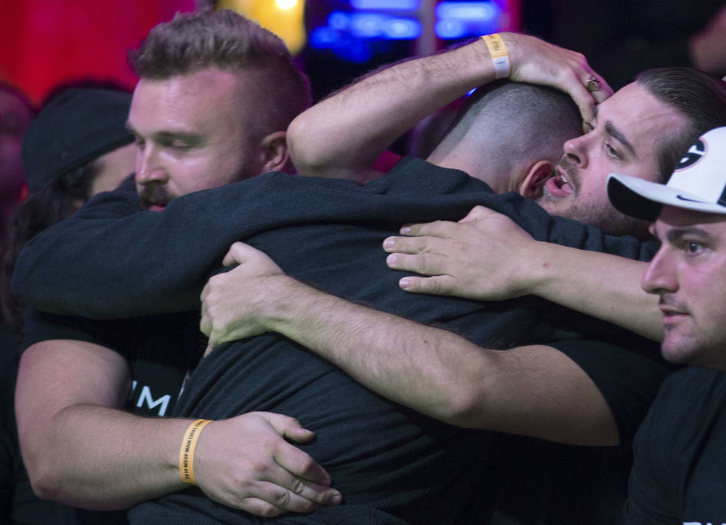 Alex Livingston, back, from Canada, is consoled by fans after being eliminated during the World ...