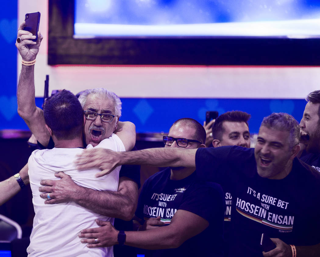 Hossein Ensan hugs his brother Rahim Ensan after winning the World Series of Poker Main Event o ...