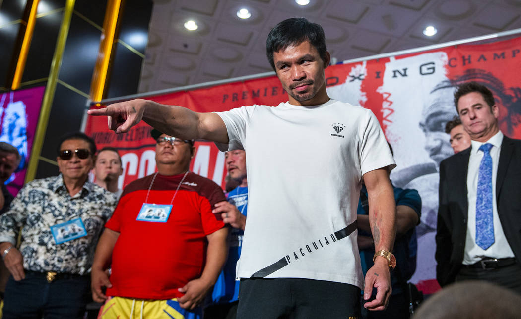 Boxer Manny Pacquiao points to the crowd during his grand arrival to the MGM Grand on Tuesday, ...