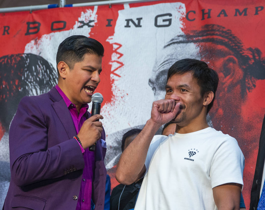 Emcee Ray Flores, left, interviews boxer Manny Pacquiao during his grand arrival to the MGM Gra ...