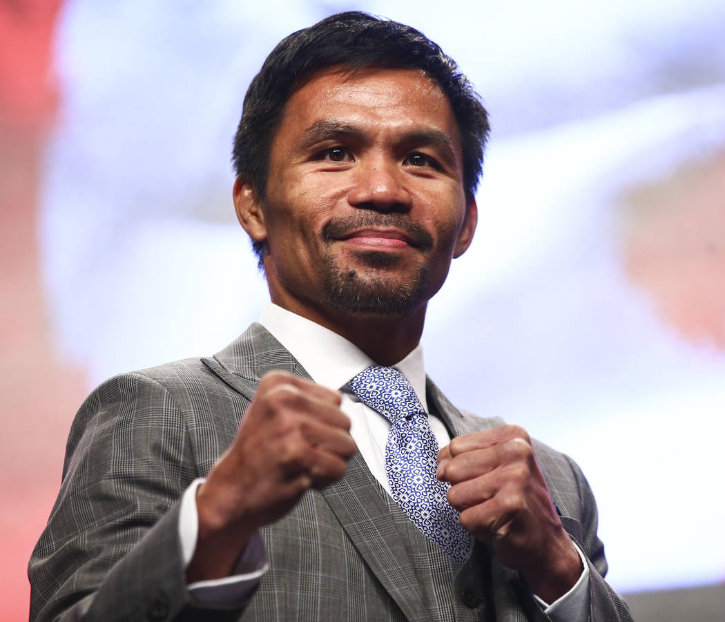 Manny Pacquiao poses for pictures during a press conference ahead of his WBA welterweight champ ...