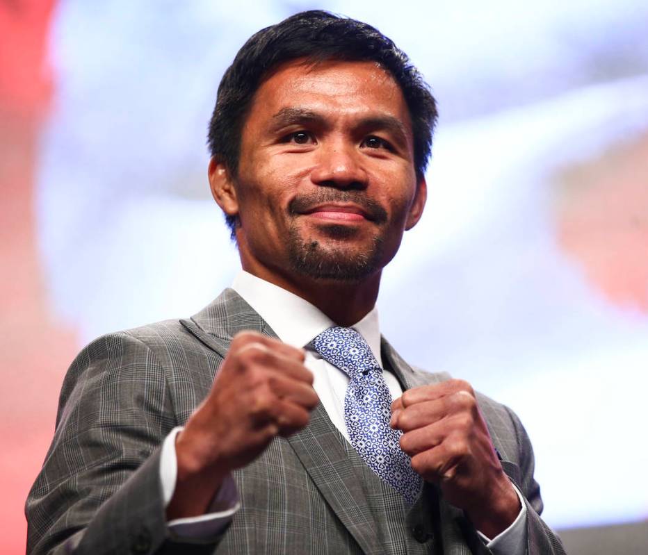 Manny Pacquiao poses for pictures during a press conference ahead of his WBA welterweight champ ...
