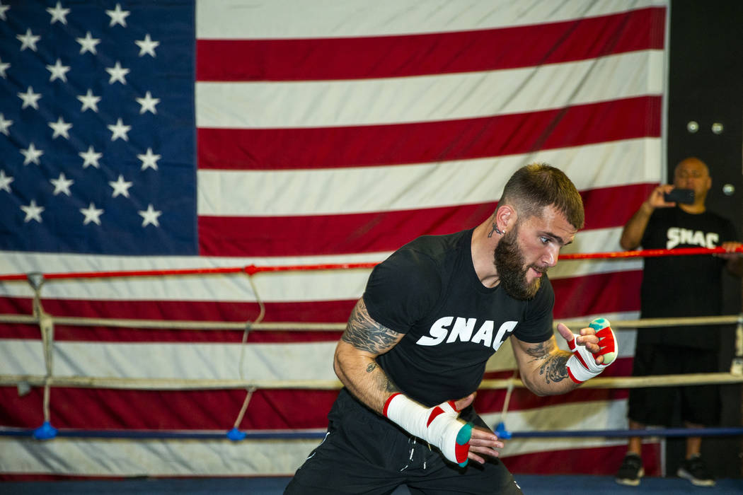 Boxer Caleb Plant, IBF super middleweight champion, warms up in the ring during a media day/ope ...