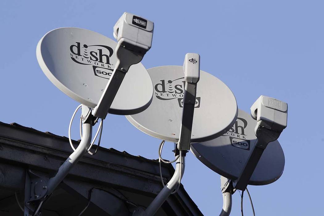 FILE - In this Feb. 23, 2011, file photo, Dish Network satellite dishes are shown at an apartme ...