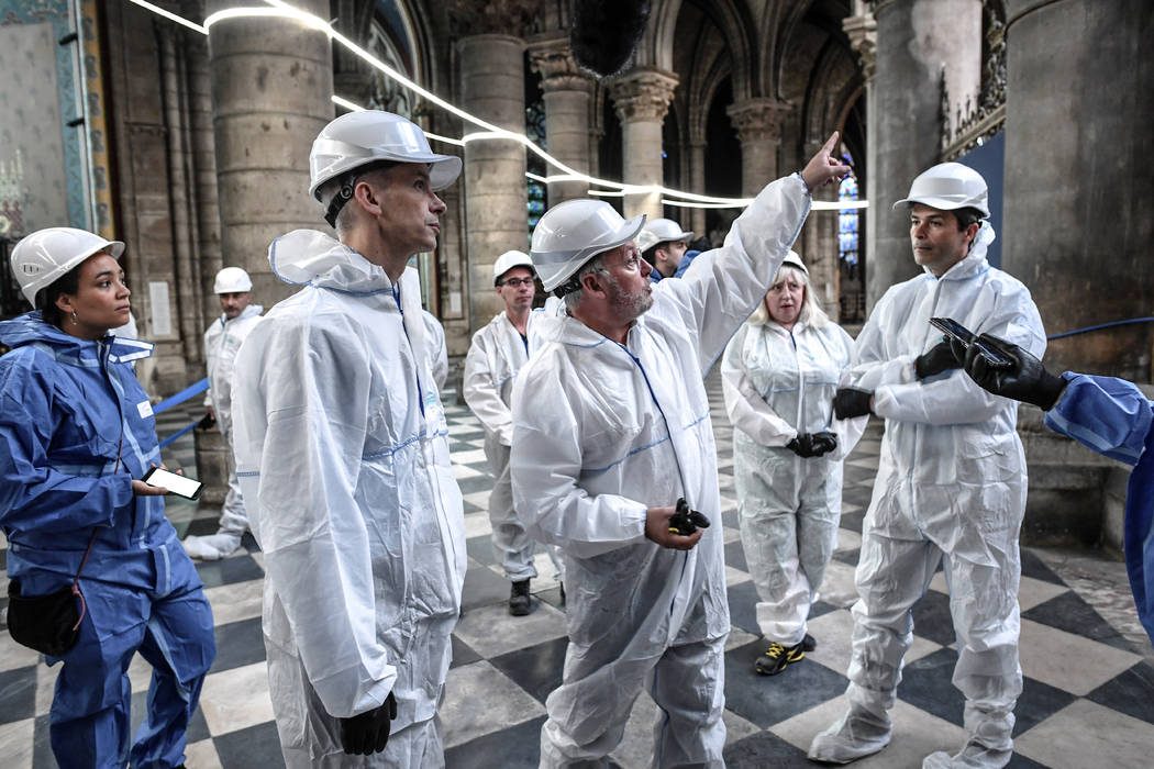 French Culture Minister Franck Riester, second left, listens to French chief architect of histo ...