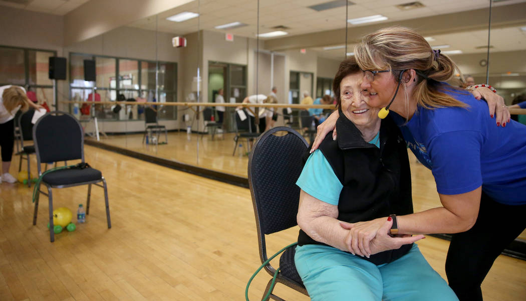 Anita Stephens, right, hugs Rachel Fried before a Body Flow class as part of the SilverSneakers ...
