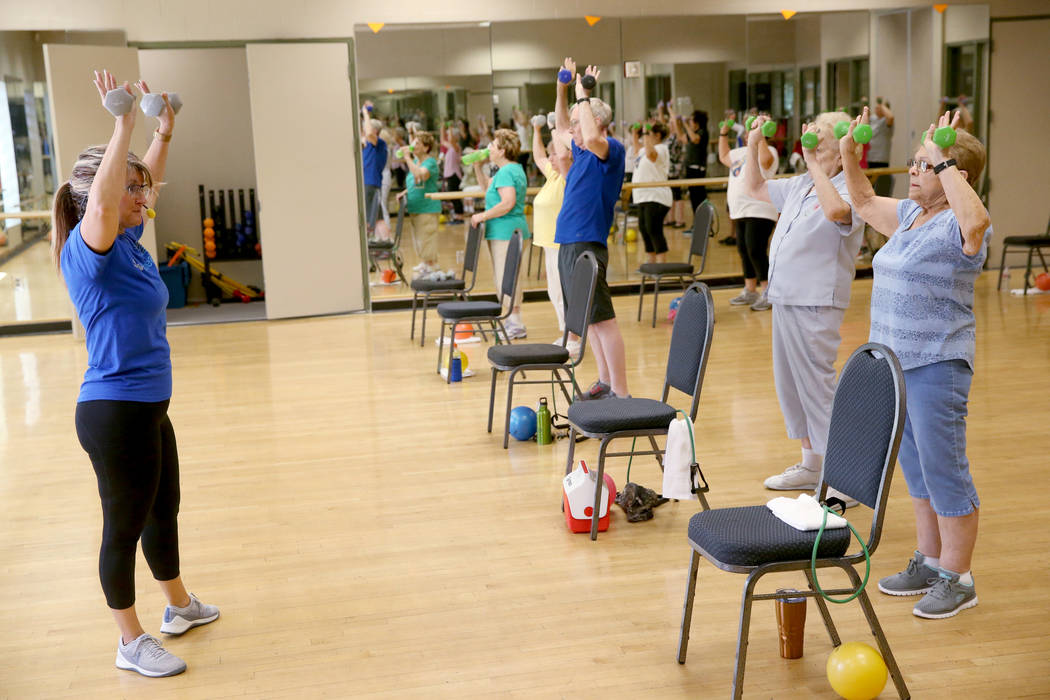 Anita Stephens teaches a Body Flow class as part of the SilverSneakers fitness program at Duran ...