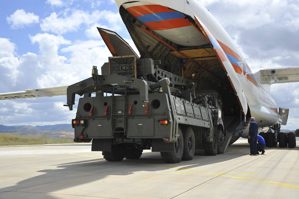 Military vehicles and equipment, parts of the S-400 air defense systems, are unloaded from a Ru ...