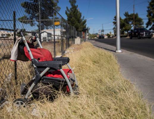 An abandoned baby stroller is propped up against a fence near the intersection of West Bonanza ...