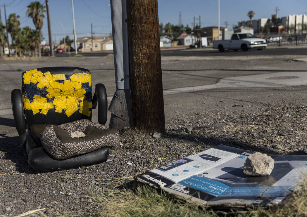 Discarded furniture and empty boxes lay in a field close to the intersection of South Las Vegas ...