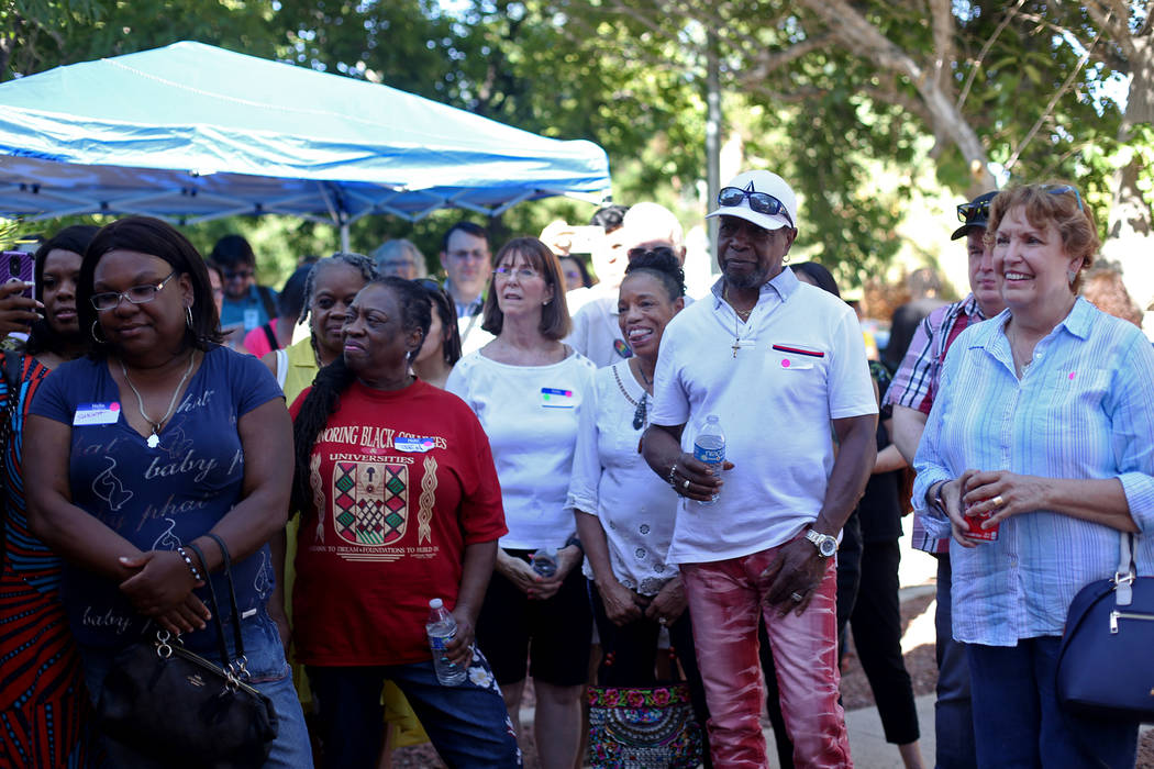 Guests listen to a campaign staff member at a meet-n-greet with campaign staff at the new offic ...