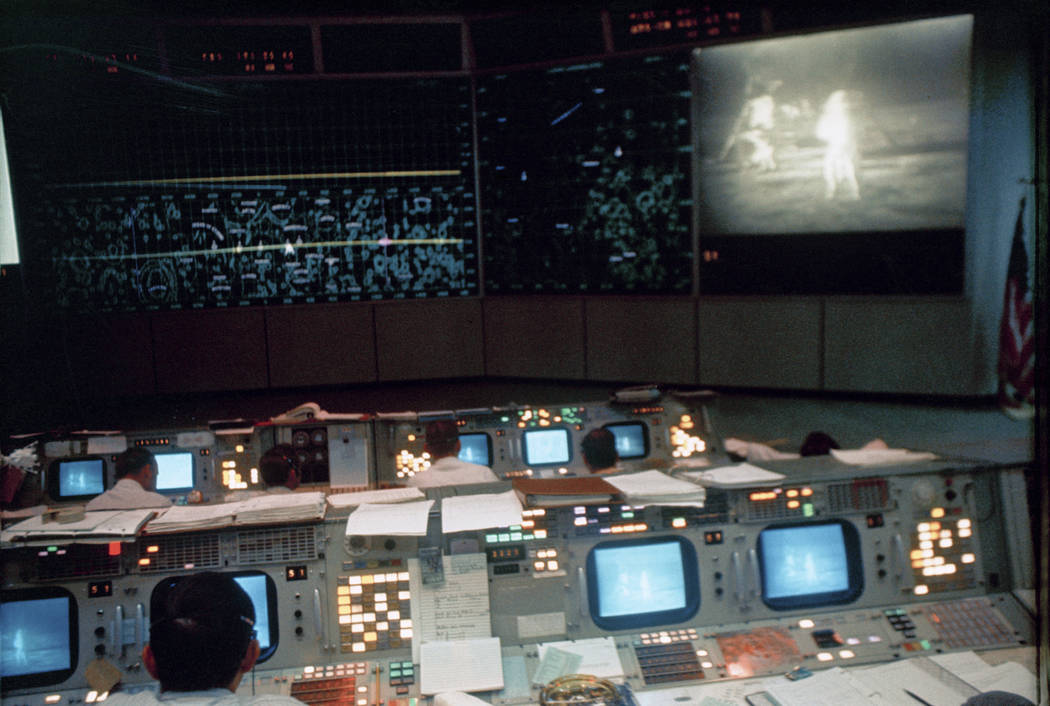 In this July 20, 1969 photo made available by NASA, flight controllers work in the Mission Oper ...