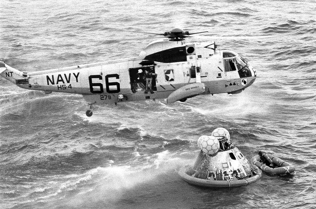 In this July 24, 1969 photo from the U.S. Navy, Navy UDT swimmer Clancy Hatleberg prepares to j ...