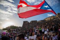 Demonstrators march against governor Ricardo Rosello, in San Juan, Puerto Rico, Wednesday, July ...