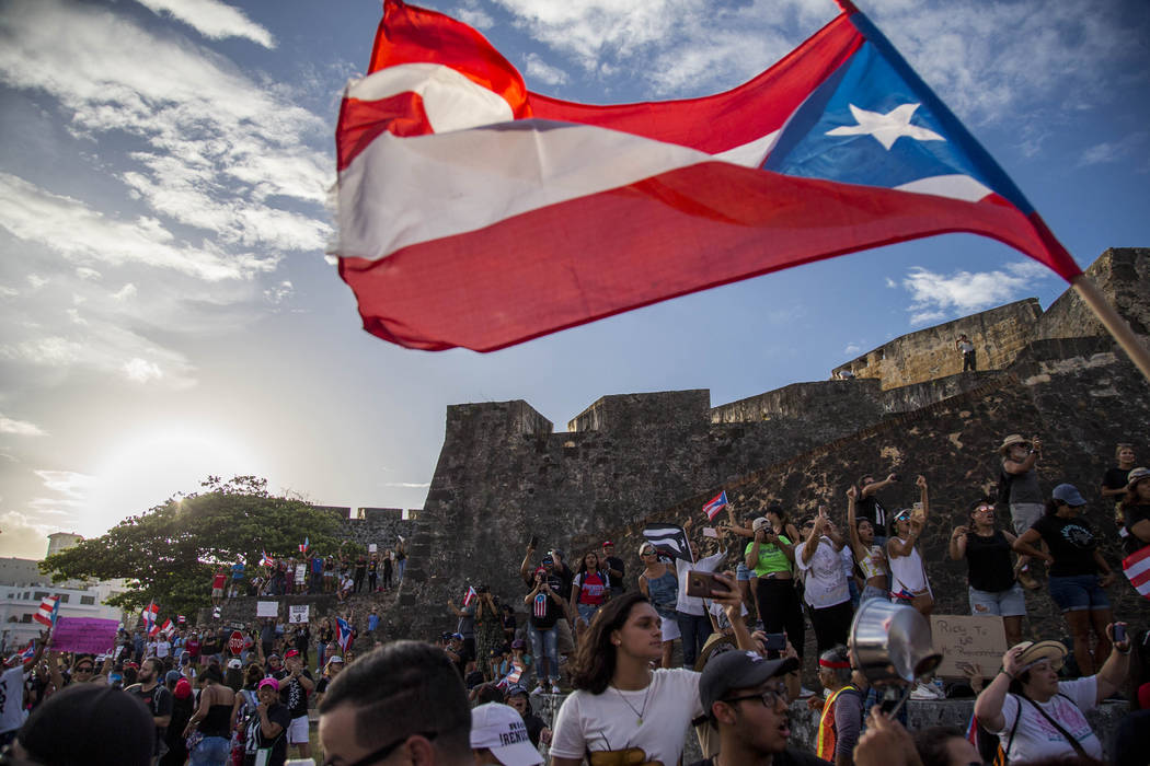 Demonstrators march against governor Ricardo Rosello, in San Juan, Puerto Rico, Wednesday, July ...