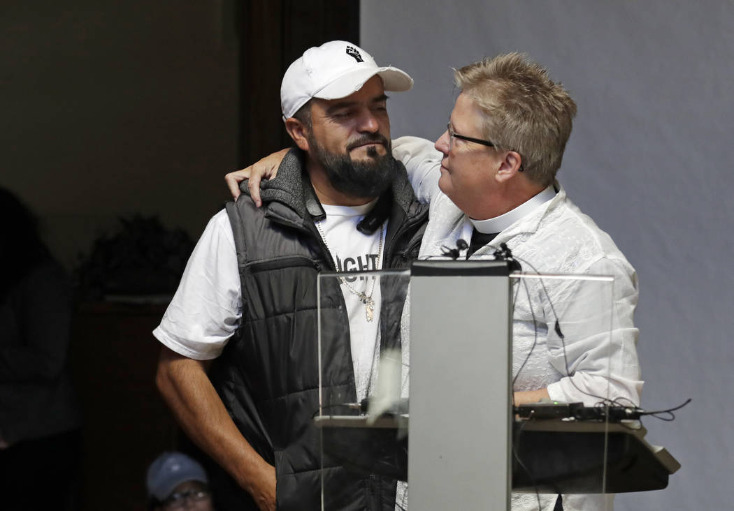 Jose Robles, left, is embraced by Gethsemane Lutheran Church Pastor Joanne Engquist inside Rive ...