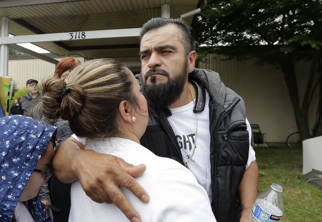 Jose Robles embraces his wife, Susana Robles, after leaving Riverton Park United Methodist Chur ...