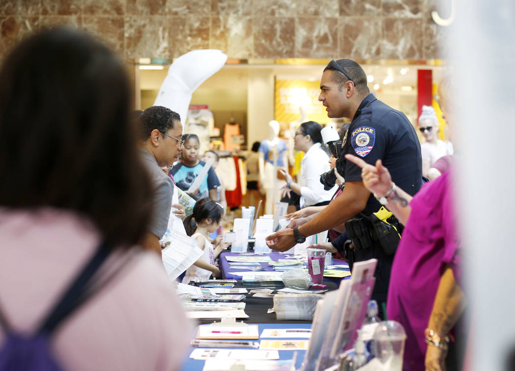 Individuals visit booths during the annual Cox Back to School Fair at the Galleria at Sunset ma ...