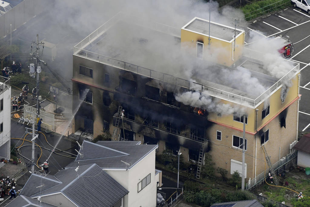 Smoke billows from a three-story building of Kyoto Animation in a fire in Kyoto, western Japan, ...