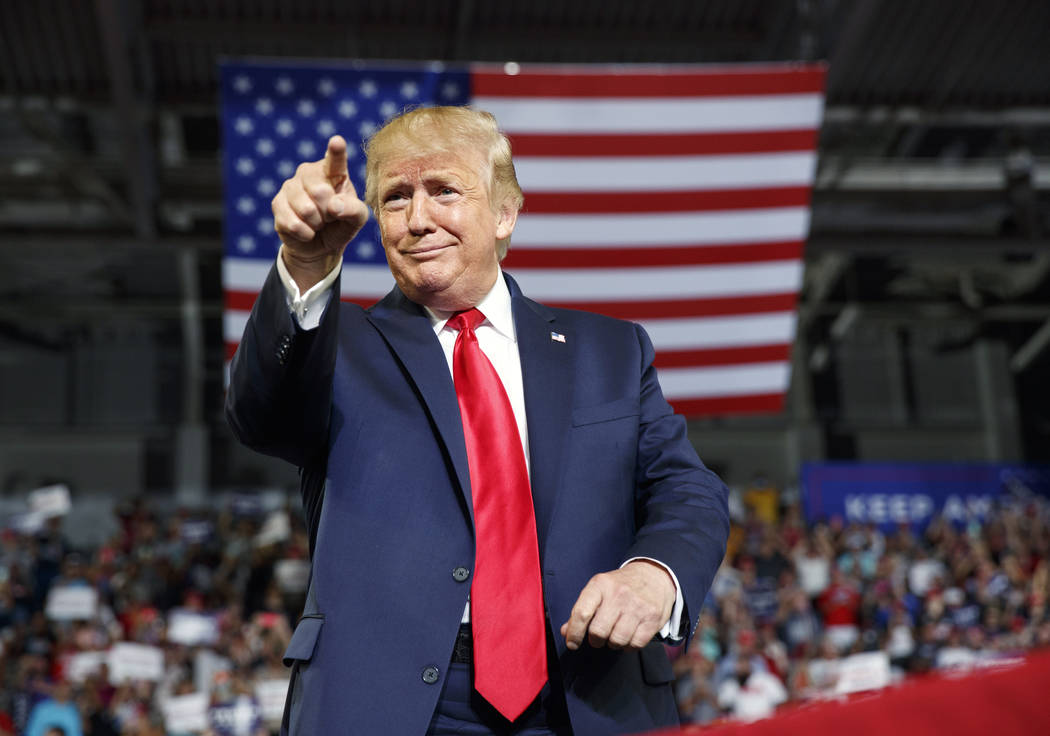 President Donald Trump gestures to the crowd as he arrives to speak at a campaign rally at Will ...