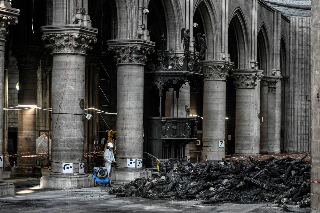 Workers are pictured during preliminary work at the Notre-Dame de Paris Cathedral, Wednesday, J ...