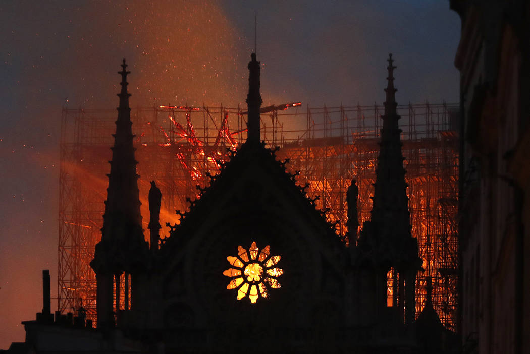 FILE - Flames and smoke rise from Notre Dame cathedral as it burns in Paris, Monday, April 15, ...