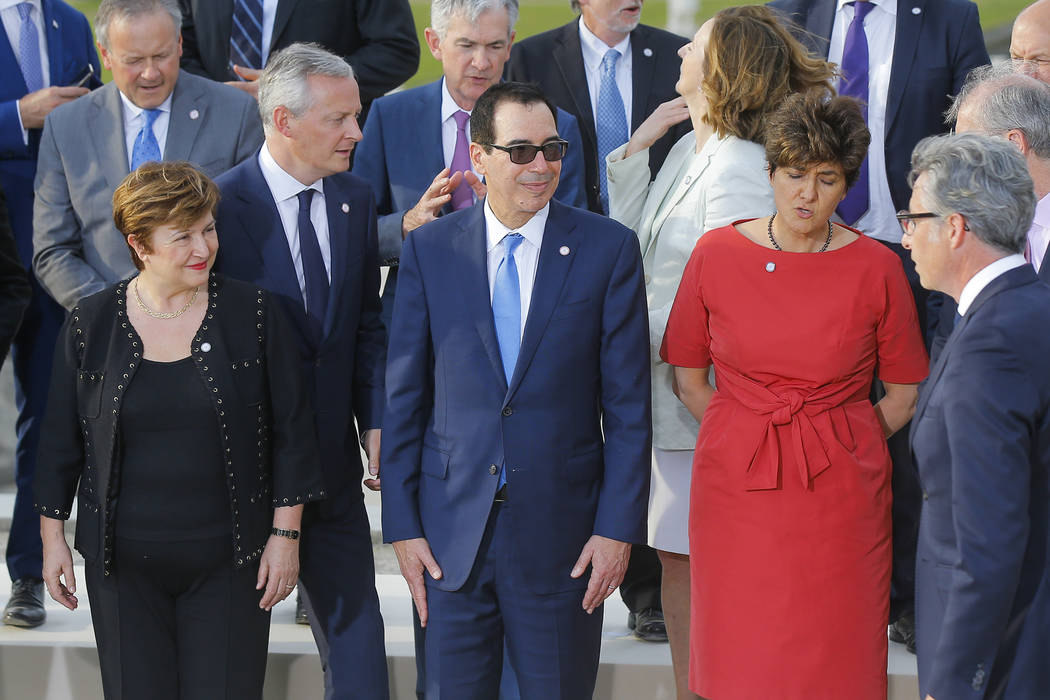 US Treasury Secretary Steve Mnuchin, front center, stands next to Chief Executive of the World ...