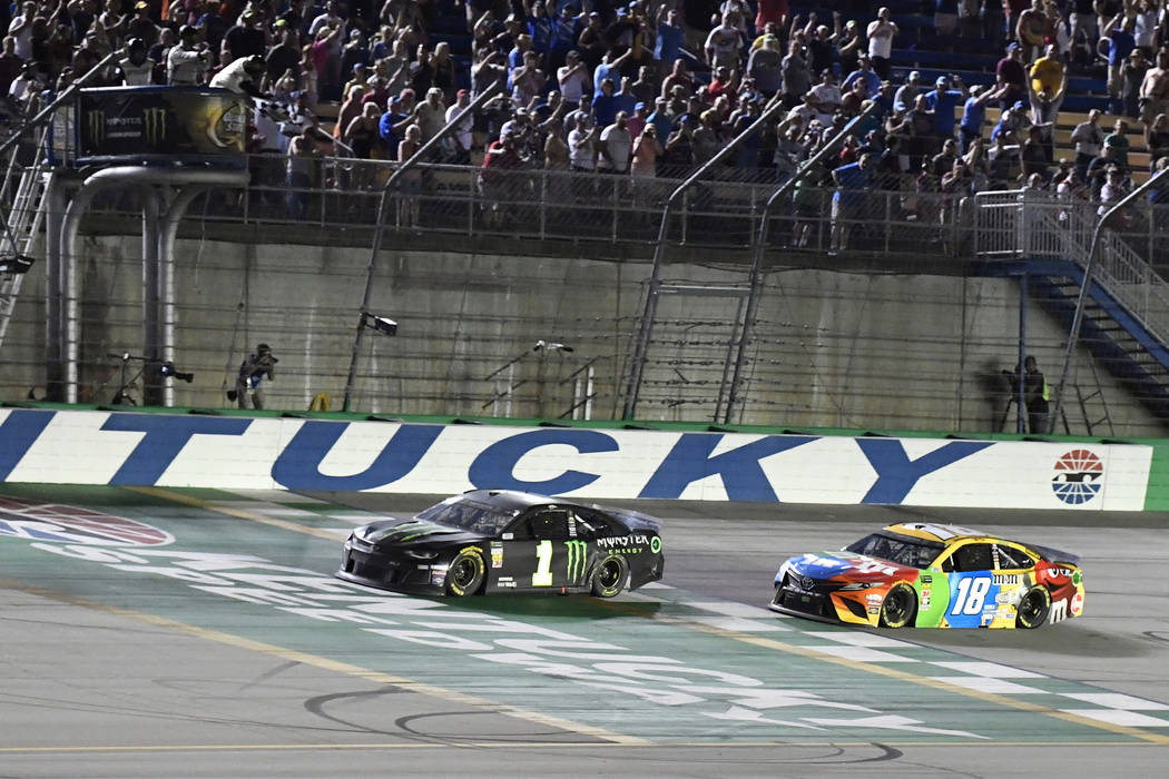 Kurt Busch crosses the finish line ahead of Kyle Busch (18) to win the NASCAR Cup Series auto r ...