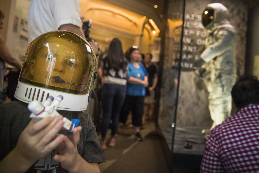 Jack Heely, 5, of Alexandria, Va., wears a toy space helmet as he arrives as one of the first v ...