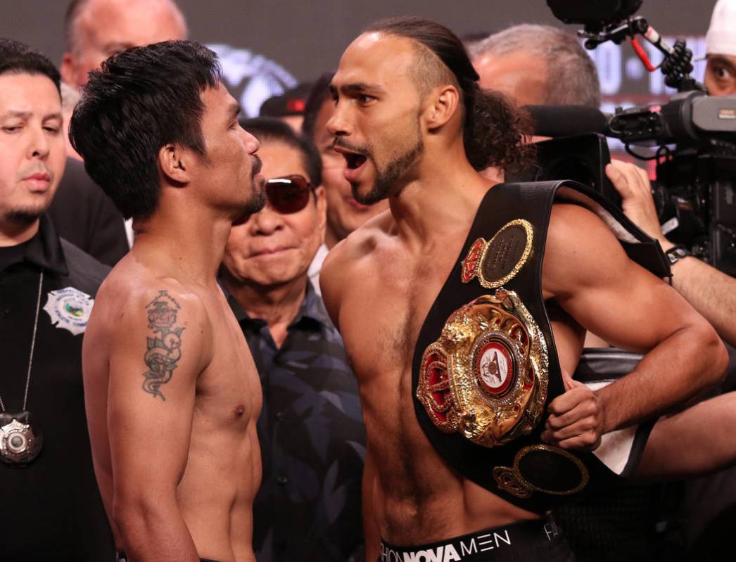 Manny Pacquiao, left, squares off with Keith Thurman during the official weigh-in at the MGM Gr ...