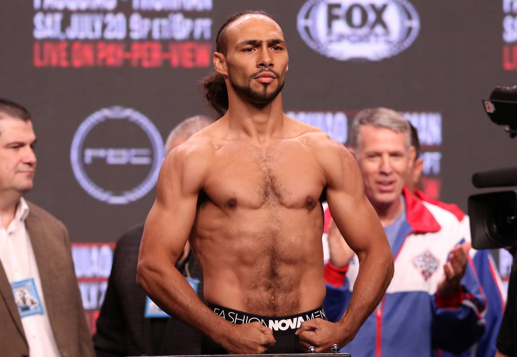 Keith Thurman flexes on the scale during the official weigh-in at the MGM Grand Garden Arena in ...