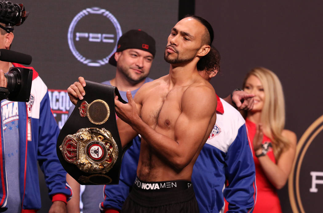 Keith Thurman picks up his championship belt during the official weigh-in at the MGM Grand Gard ...