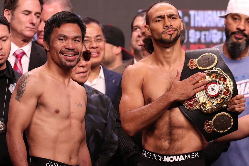 Manny Pacquiao, left, squares off with Keith Thurman during the official weigh-in at the MGM Gr ...