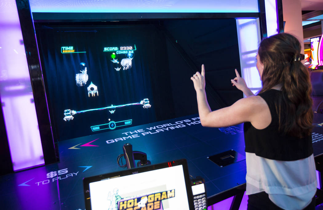 Ashley Crowder, CEO and co-founder of VNTANA, plays a gesture-controlled holographic game as a ...