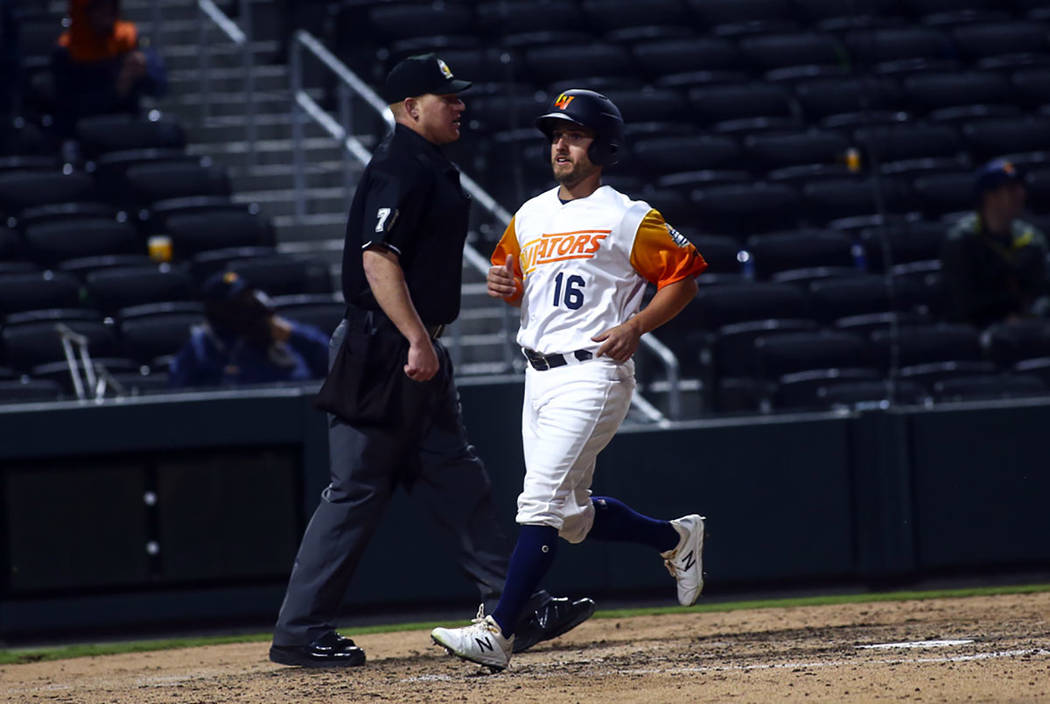 Las Vegas Aviators left fielder Mark Payton (16) scores a run against the Sacramento River Cats ...