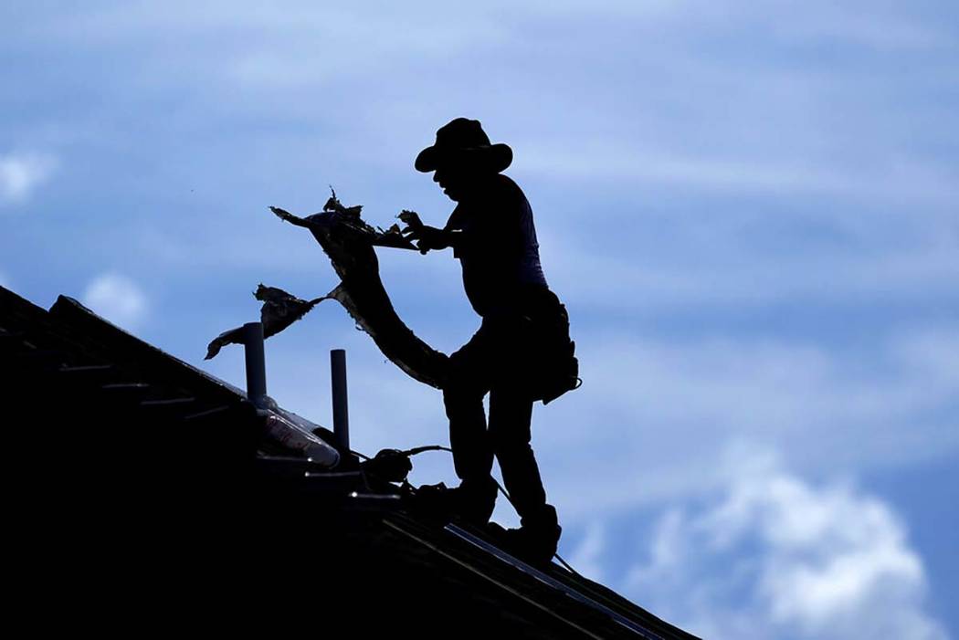 A roofer works on a new home under construction Thursday, July 18, 2019, in Houston. A heat wav ...