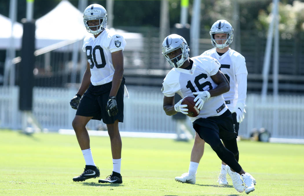 Oakland Raiders wide receiver Johnny Holton (16) runs with the football as wide receivers Saeed ...