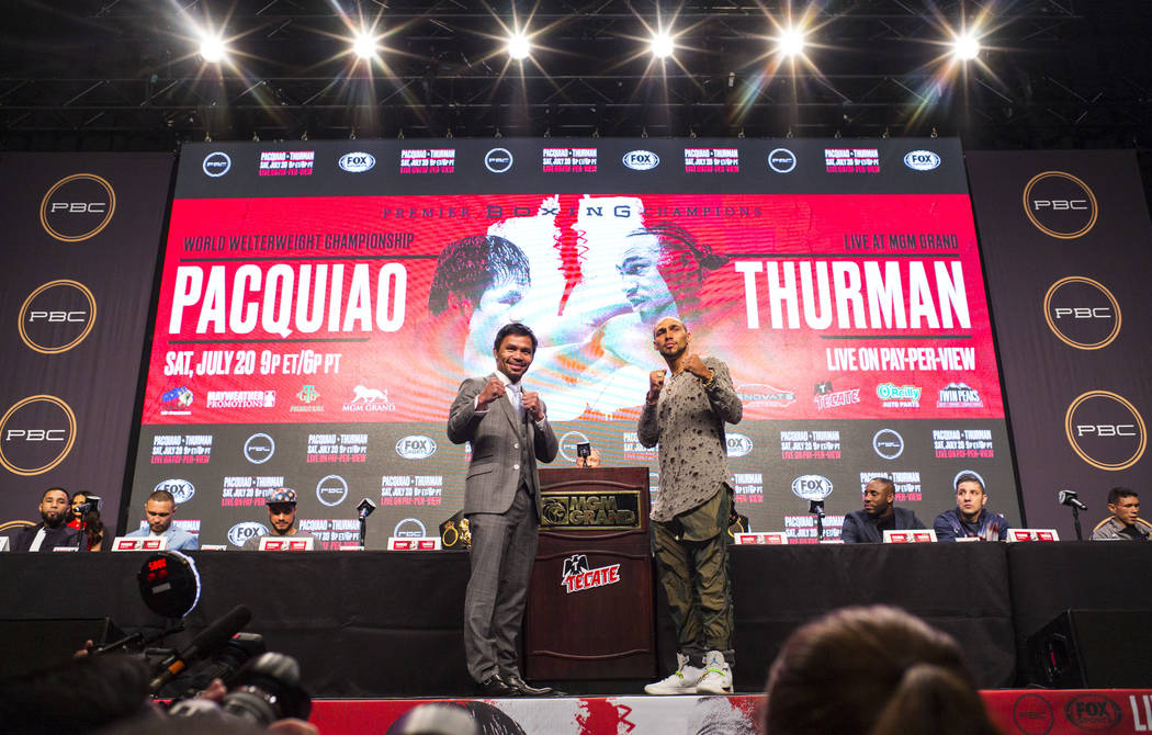 Manny Pacquiao, left, and Keith Thurman pose for pictures during a press conference ahead of th ...