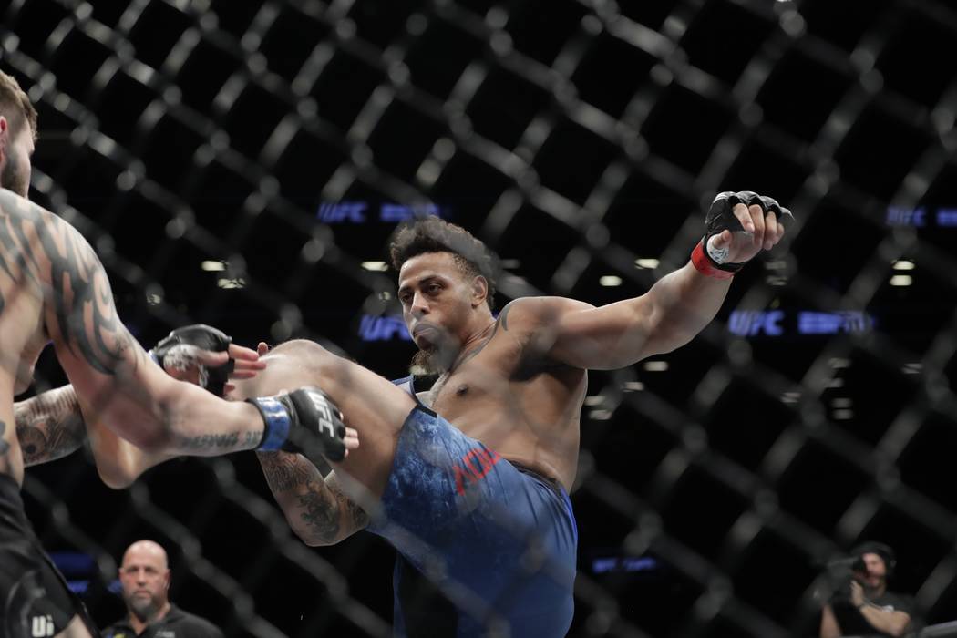 Greg Hardy kicks Allen Crowder during the first round of a heavyweight mixed martial arts bout ...