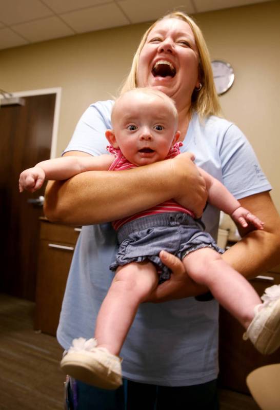 Occupational Therapist Chris Gutierrez plays with Eden Smyth, 6 months, during the first-ever N ...