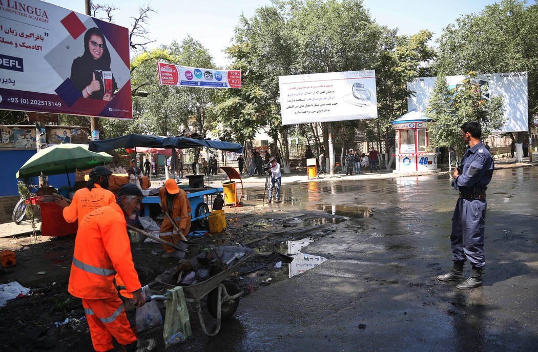 Afghan security forces stand guard near the site of an explosion in Kabul, Afghanistan, Friday, ...