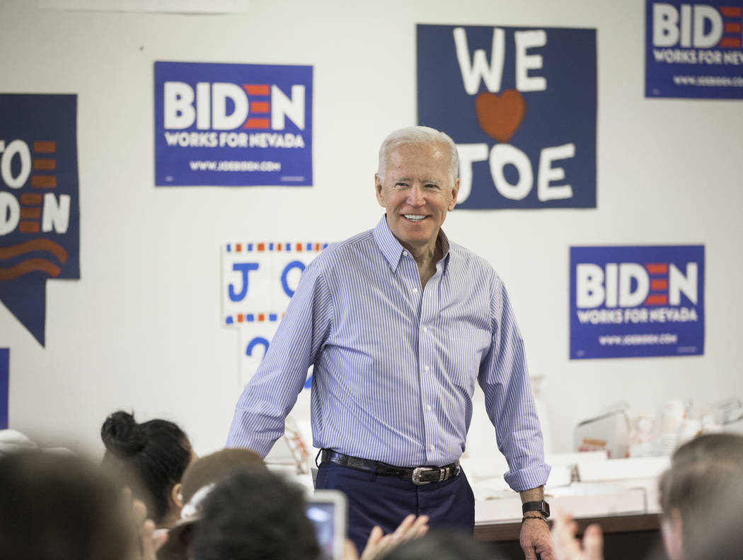 Democratic presidential candidate former Vice President Joe Biden, middle, walks into the room ...