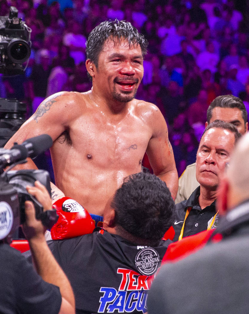 Manny Pacquiao is lifted in celebration after defeating Keith Thurman in their WBA super welter ...